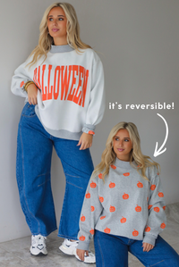 A woman wearing a light grey and dark grey trim oversized sweatshirt that says "HALLOWEEN" in collegiate font on the front, with jack-o-lantern details on it, paired with dark wash denim jeans, standing indoors against a white wall with white marble flooring. To the right of the photo shows the same model with the background removed, showing the inside of the reversible sweatshirt with jack-o-lanterns showing in a repeating pattern throughout. 