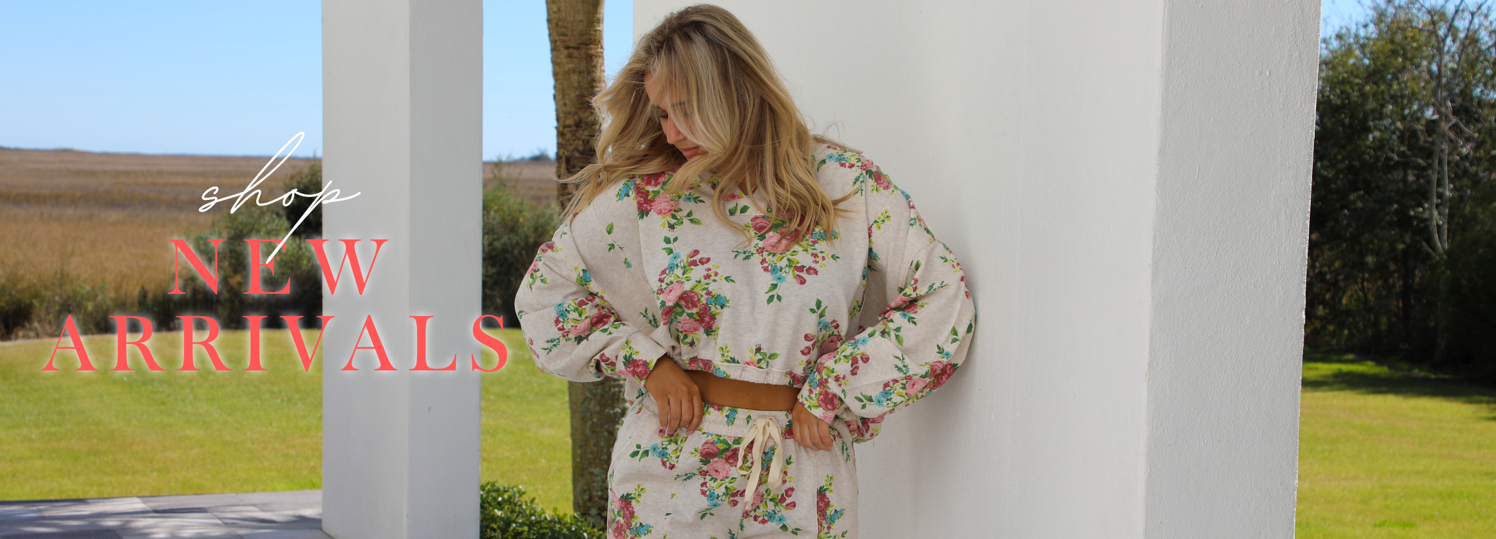 Woman in floral set standing outdoors with 'New Arrivals' text overlay